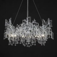 A striking modern chandelier suspended against a black background. The fixture features an intricate design of intertwining clear glass or crystal elements forming an abstract, organic structure. From this complex upper frame, numerous thin glass rods of varying lengths hang down, each terminating in a small spherical glass droplet. The overall shape is roughly rectangular but with an irregular, natural-looking silhouette. The chandelier is illuminated from within, with several light sources visible among the glass elements, creating a warm glow and causing the glass to sparkle brilliantly against the dark backdrop. Thin wires suspending the chandelier are visible at the top. The design blends elements reminiscent of icicles, rain, or abstract tree branches, resulting in a piece that is both sculptural and functional. This chandelier would serve as a dramatic focal point in a contemporary or luxury interior space.