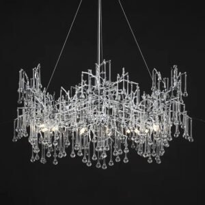 A striking modern chandelier suspended against a black background. The fixture features an intricate design of intertwining clear glass or crystal elements forming an abstract, organic structure. From this complex upper frame, numerous thin glass rods of varying lengths hang down, each terminating in a small spherical glass droplet. The overall shape is roughly rectangular but with an irregular, natural-looking silhouette. The chandelier is illuminated from within, with several light sources visible among the glass elements, creating a warm glow and causing the glass to sparkle brilliantly against the dark backdrop. Thin wires suspending the chandelier are visible at the top. The design blends elements reminiscent of icicles, rain, or abstract tree branches, resulting in a piece that is both sculptural and functional. This chandelier would serve as a dramatic focal point in a contemporary or luxury interior space.