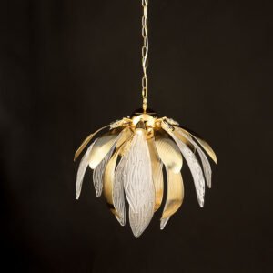 An exquisite pendant chandelier illuminated against a dark background, showcasing a harmonious blend of gold and crystal elements. The fixture resembles a blooming flower or artichoke, with alternating gold and crystal petals radiating outward from a central core. The gold petals have a smooth, ribbed surface with a warm metallic sheen, curving gracefully outward. The crystal petals are clear and intricately textured with a pattern reminiscent of delicate leaf veins, adding a translucent and ethereal quality to the design. The light emanating from within the chandelier highlights the intricate details of both the gold and crystal components, creating a warm, inviting glow. The crystal elements catch and refract the light, producing a soft, sparkling effect. The chandelier is suspended by a delicate gold chain, adding to its refined appearance. This piece masterfully combines organic, nature-inspired forms with luxurious materials, resulting in a striking blend of contemporary design and classic elegance. The illuminated chandelier appears to float in the darkness, emphasizing its role as both a functional light source and a captivating decorative element, perfect for creating a focal point in any sophisticated interior space.