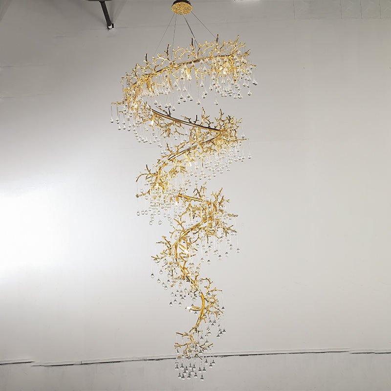 Luxe Gold Spiral Branch Chandelier with Crystal Droplets complementing a stone fireplace