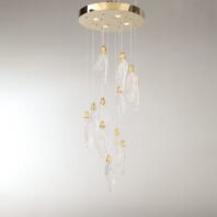 An elegant branch chandelier featuring translucent glass leaves suspended at varying lengths from a circular gold-toned base. Each leaf-shaped glass element is delicately textured to mimic real foliage and is topped with a small, ornate gold cap. The chandelier's design creates a graceful, cascading effect, with leaves arranged in a natural, organic pattern. LED spotlights are integrated into the circular base, providing additional illumination. This modern branch chandelier blends nature-inspired forms with luxurious materials, creating a stunning focal point that combines the airy lightness of glass with the warmth of gold accents.