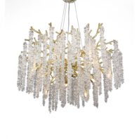 An elegant chandelier featuring cascading crystal strands suspended from gold-toned branches. The fixture has a circular shape with numerous vertical strings of clear crystal elements hanging down, creating a waterfall effect. The gold-colored metal branches are visible among the crystals, adding warmth and contrast to the design. The chandelier is illuminated from within, causing the crystals to sparkle and refract light. It's suspended by thin wires from a central mounting point. The overall effect is one of opulence and sophistication, reminiscent of a glittering crystal forest or frozen waterfall.