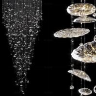 A large chandelier featuring two distinct custom lighting designs. On the left, a cascading waterfall of crystal droplets creates a mesmerizing rain-like effect. On the right, tiered crystal discs reminiscent of celestial bodies are suspended at varying heights. This big hotel chandelier combines delicate, sparkling elements with bold sculptural forms. The custom lighting piece casts a magical, starry glow against a dark background, perfect for creating an enchanting atmosphere in luxurious hotel spaces. This spectacular chandelier showcases the versatility of crystal in modern lighting design.