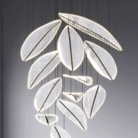 A striking large hotel chandelier showcasing innovative custom lighting design. This big chandelier features multiple leaf-shaped elements suspended at varying heights against a dark background. Each leaf is made of a transparent material with intricate vein-like patterns, illuminated along its edges by bright LED lights. The leaves vary in size and are arranged in an organic, cascading composition reminiscent of falling foliage. The glowing outlines of the leaves create a dramatic contrast against the dark surroundings, giving the impression of floating, luminous botanical forms. This avant-garde piece exemplifies cutting-edge custom lighting, perfect for creating a captivating focal point in modern, luxurious hotel spaces. The chandelier's design blends natural inspiration with high-tech illumination, transforming the ambiance with its ethereal, nature-inspired presence and casting a soft, diffused light that enhances the surrounding space.